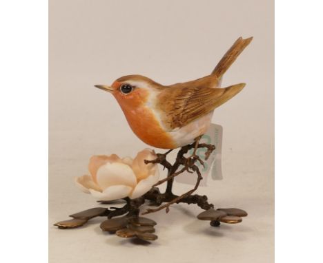 An Albany Fine China Co. Ceramic bird study incorporating metal. Modelled as a Robin with a realistic flower. Height: approx.