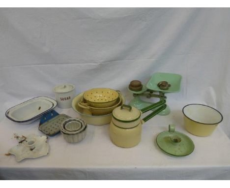 A selection of kitchen enamel wares including a sugar canister, a soap dish, colanders, candle holders, bowls etc. and a set 