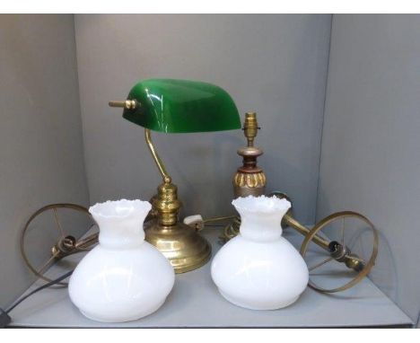 A pair of brass wall lights with white opaque glass shades, a desk lamp with green shade and seven others.