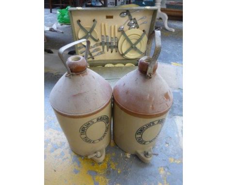 A picnic hamper and two large stoneware flagons. 