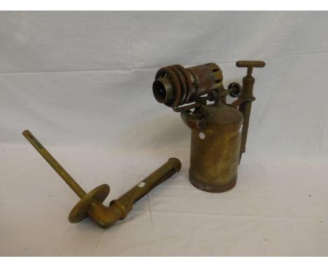 A large Primus no.865 brass lamp and a brass cased thermometer.