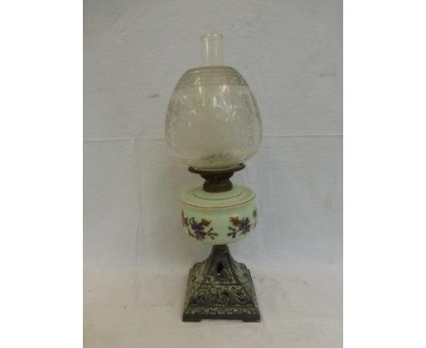 A Victorian oil lamp with fretwork base and opaline glass reservoir with etched shade. 