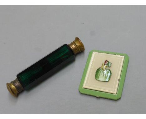 A Victorian green glass double ended scent bottle with stoppers and an enamelled compact surmounted by a 19th Century lady. 