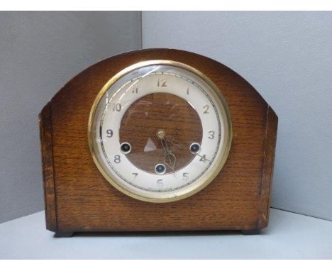 An oak cased mantle clock with Westminster chimes. 