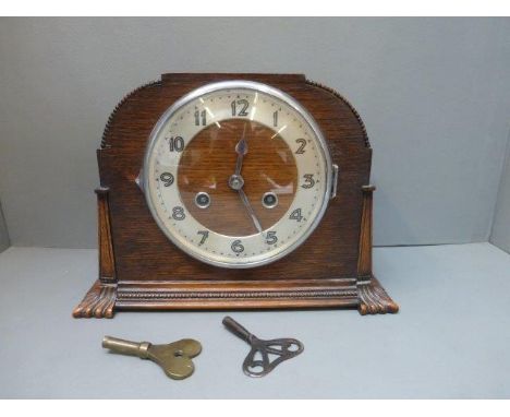 A Sanders and Company oak cased mantle clock with retailer's plaque. 