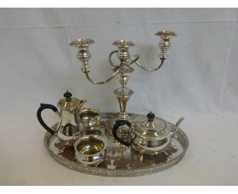 A silver plated tea set, a candelabra and an oval galleied tray. 