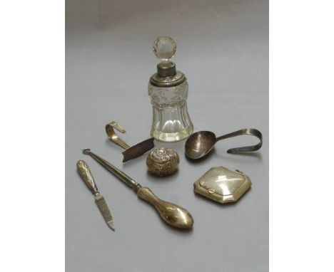 An assortment of silver including a pill pot, a button hook, a tea caddy spoon etc. 
