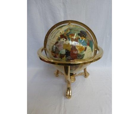 A large brass mounted tabletop globe set with semi precious stones. 