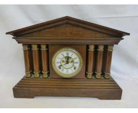 A New Haven Clock Co. oak cased mantle clock in the form of an acropolis. 
