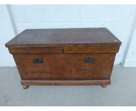 A 19th Century stained pine trunk with internal candle box and two pigeon holes. 