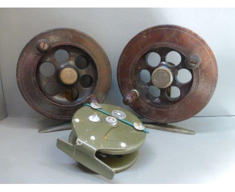 Two large mahogany and brass salmon fishing reels and a Strike Right Hydraflo fishing reel. 