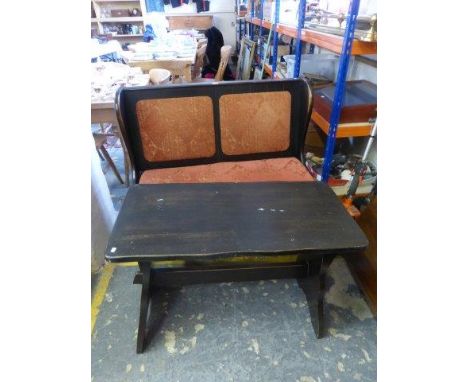 A small two seater wooden settle and side table. 