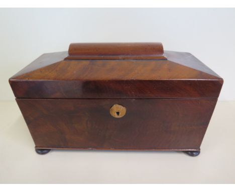 A late Georgian sarcophagus shape mahogany three section tea caddy, standing on bun feet, in clean condition 