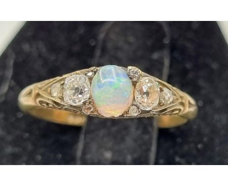 8ct Gold Ring Opal &amp; Diamonds 2.8gms. Central opal, two diamond 0.1ct and five smaller diamonds.
