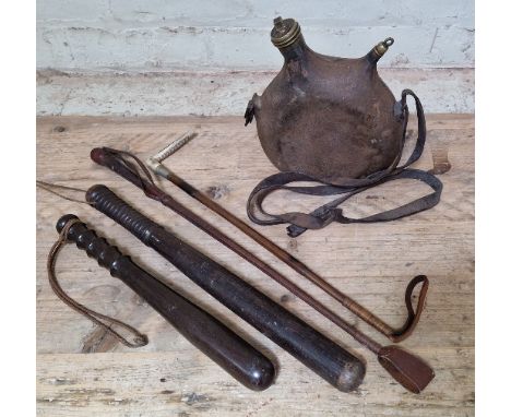 A box of assorted militaria comprising of a French WWII water bottle, 2 vintage hardwood truncheons &amp; 2 vintage riding cr