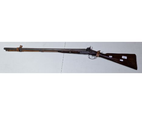 A 19th century muzzle loading percussion double barrel shotgun.  