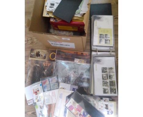 A box of assorted stamps and covers, mint stamp packs, FDCs, two New Zealand Lord of The Rings unopened presentation packs et