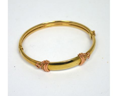 A yellow and rose gold bangle, unmarked, approx 9.6g.