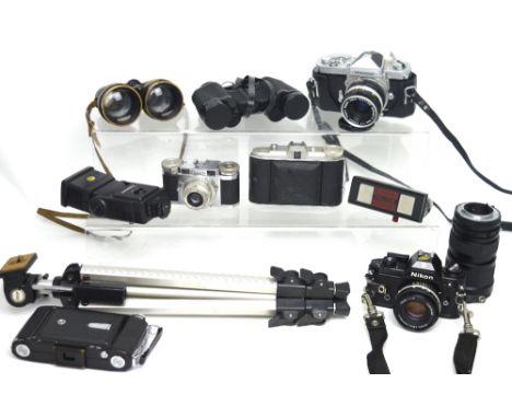 A quantity of vintage cameras, binoculars and lenses to include Nikon examples.