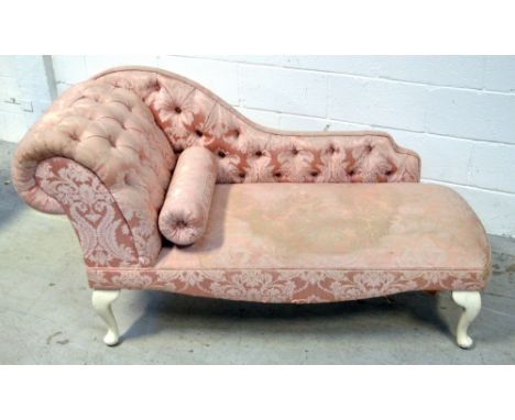 A reproduction cream painted and pink floral upholstered button back chaise longue, width 130cm.