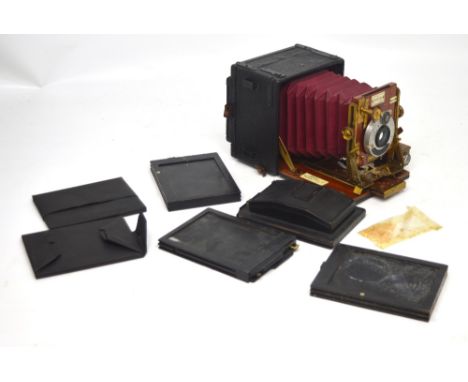 A c1902 Sanderson regular quarter plate folding bellows camera with two focusing scales to 5', a hinged focal-plane and addit