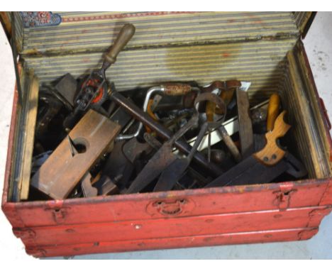 A quantity of vintage tools, contained within a red trunk.