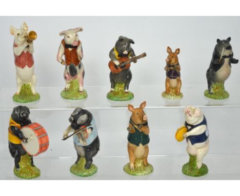 A nine-piece ceramic pig band by Beswick (two are af).