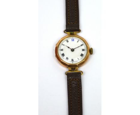 A 9ct gold ladies' wristwatch, enamel dial set with Roman numerals on leather strap.