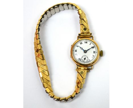 A 9ct gold ladies' wristwatch, enamel dial set with Roman numerals and subsidiary seconds hand, on plated strap.