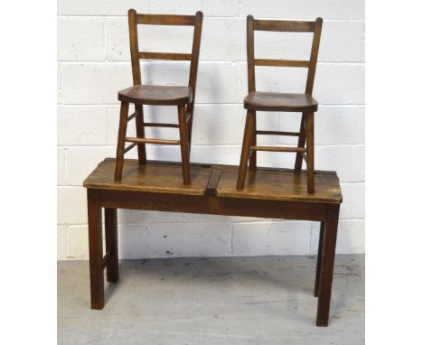 A vintage child's double school desk, width 102cm and a pair of matching ladder back chairs (3).