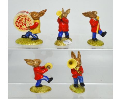 A Royal Doulton 'Bunnykins' five-piece 'Oompah Band'; DB26 'Drummer Bunnykins', DB27 'Drum Major Bunnykins', DB23 'Sousaphone