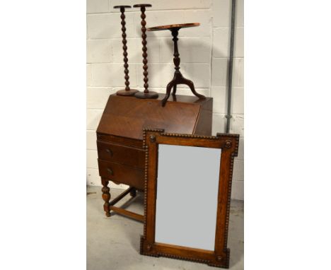 A 20th century oak bureau, width 76cm, an oak bevel edged wall mirror, width 60cm, a pair of small bobbin turned stands and a