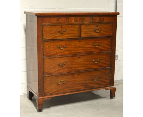 A 19th century mahogany and flamed mahogany two-over-three chest of drawers, with three secret drawers to the frieze, raised 