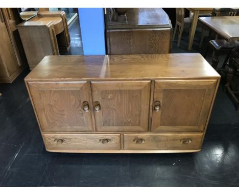 An Ercol Golden Dawn three door sideboard