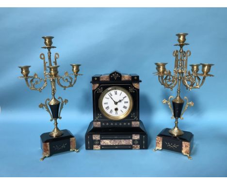 A slate mantle clock and garniture