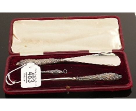 Cased large and small button hook and shoe horn: With filled silver handles. 