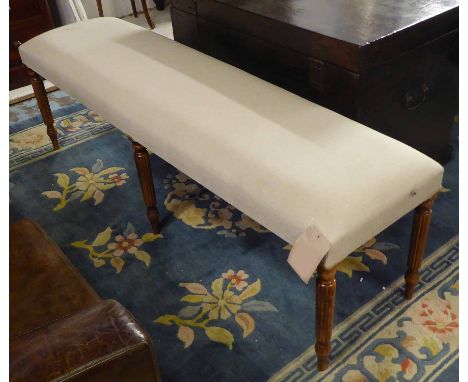 HALL BENCH, in fawn upholstery on reeded legs, 150cm x 40cm x 48cm.