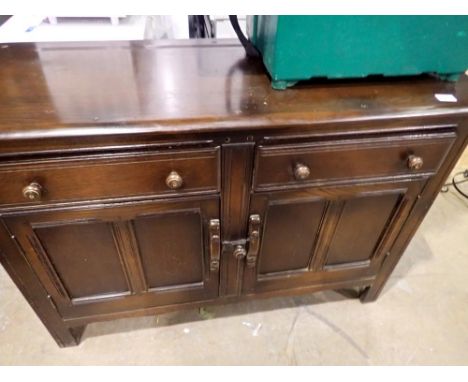 Ercol sideboard with two drawers over two cupboard doors. Not available for in-house P&amp;P 