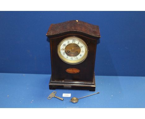 A dome cased Mantle Clock, two train movement with fancy Arabic numerals on a white and brass face (a/f), with inlaid oval ma