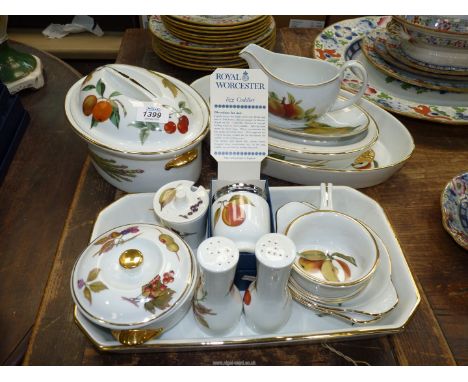 A quantity of Royal Worcester 'Evesham' serving items to include tureens, dishes, sauce jug, salt and pepper cruets, egg codd
