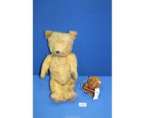 A small Steiff teddy bear in a rocking chair and a well loved teddy with leather paw pads, eyes missing, 18'' tall.