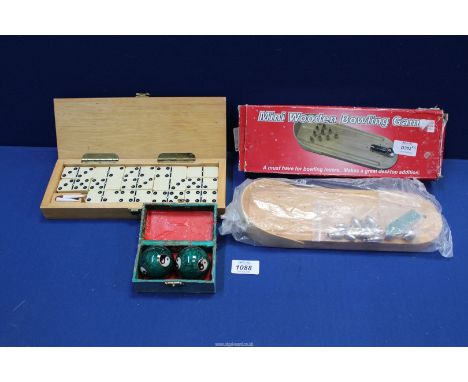 A complete boxed set of dominoes with cribbage board lid, a mini bowling game and a pair of Chinese boxed musical stress ball