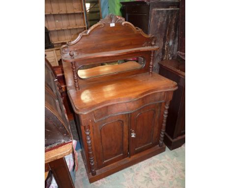A compact Mahogany Sideboard having a frieze drawer and a pair of opposing drawers below, the shaped upstand incorporating a 