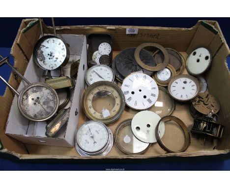 A collection of French clock parts including three movements, enamelled dials, clock bezels and brass doors, enamelled watch 