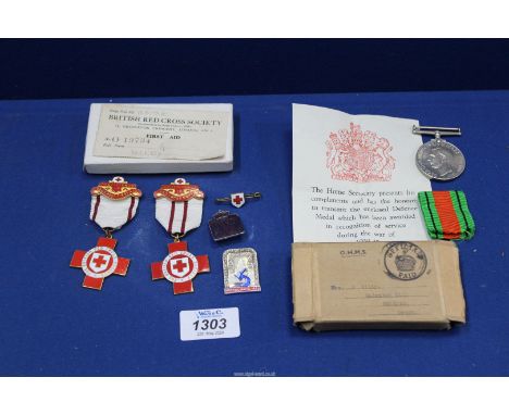 A W.V.S. Defence Badge, a W.V.S Defence Service medal with ribbon (note in original postal box as received by owner - G. Wild