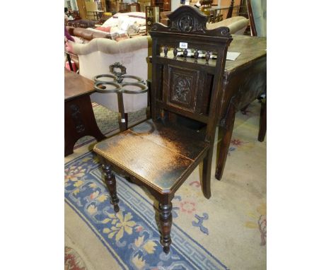 A circa 1900 Oak solid seated Hall Chair having turned bobbin details to the carved backrest and standing on turned front leg