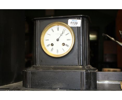A Victorian "T. Martin Paris black slate Mantle Clock with key, 9" wide x 8 1/2" high.