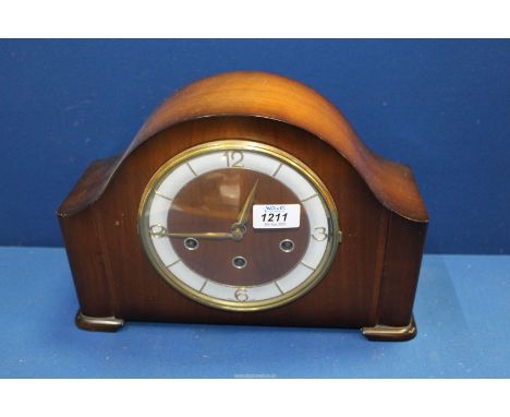 A chiming Mantle clock made in Germany, with key and pendulum, 13" wide x 9" high.