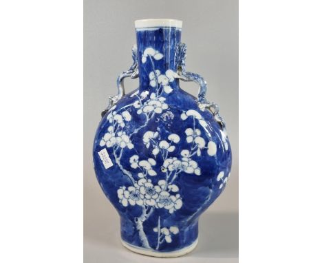 19th century Chinese export porcelain blue and white moon flask, depicting flower and prunus branches on a stylized cracked i