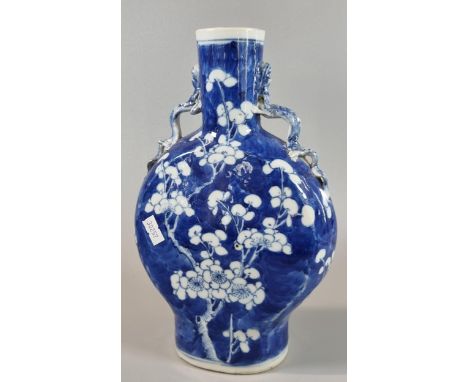 19th century Chinese export porcelain blue and white moon flask, depicting flower and prunus branches on a stylized cracked i